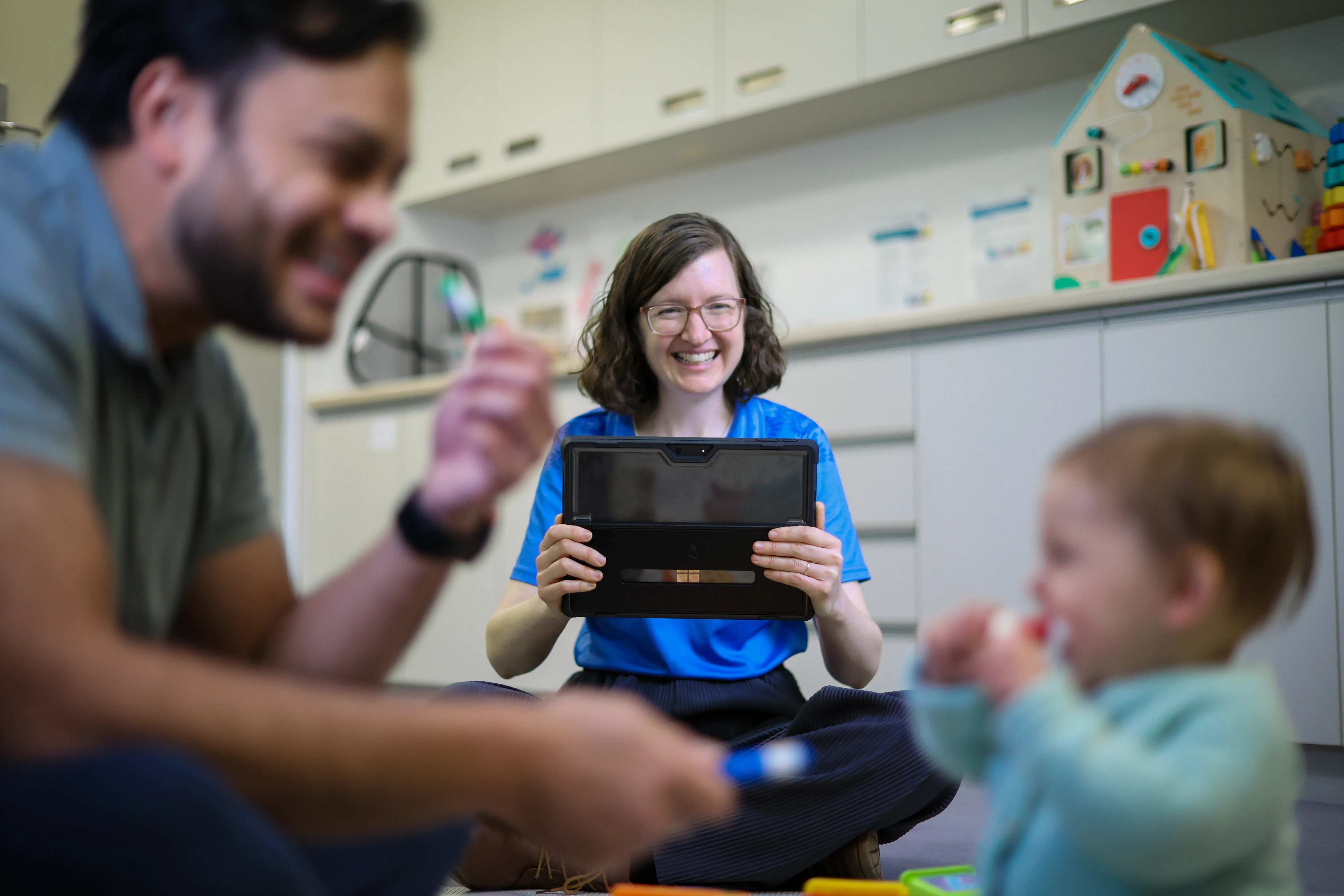 Inklings Practitioner recording male caregiver and baby for the Inklings Program
